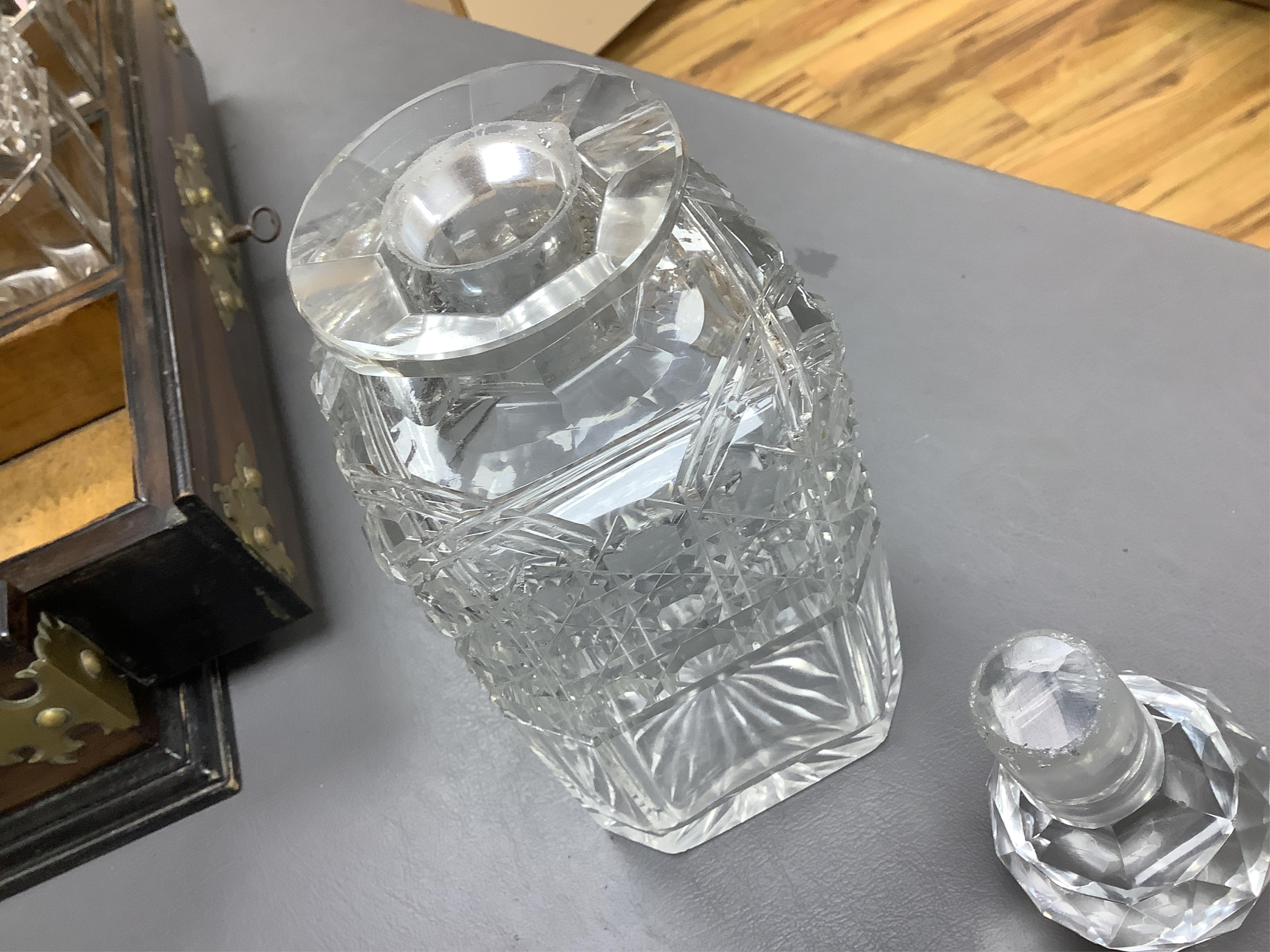 A Victorian coromandel three-bottle tantalus with brass mounts and original key